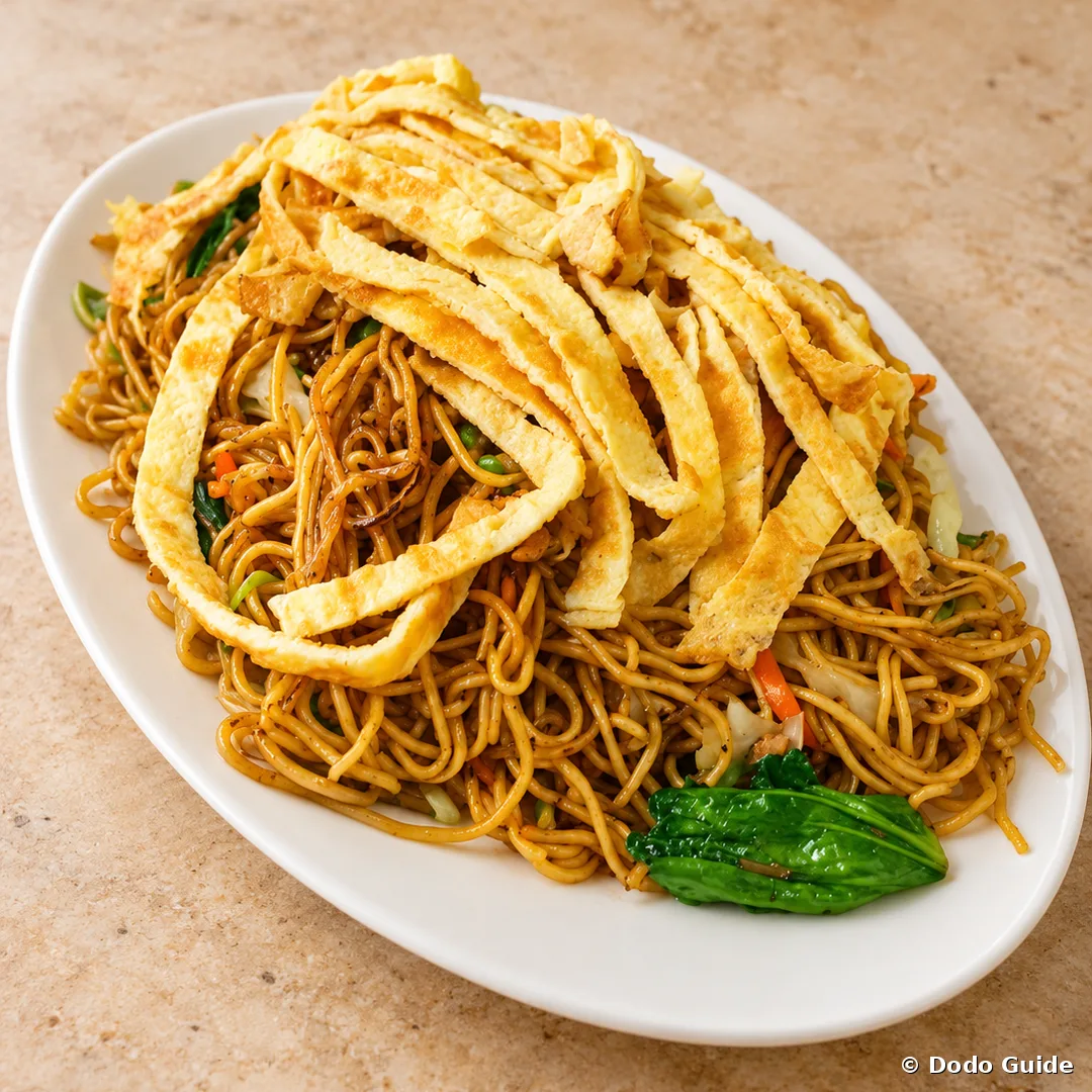 A plate of mine frit with omelette strips and greens