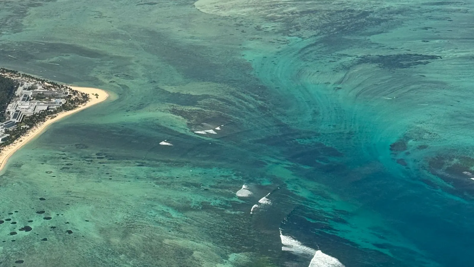 Aerial view of coral reefs in clear turquoise water