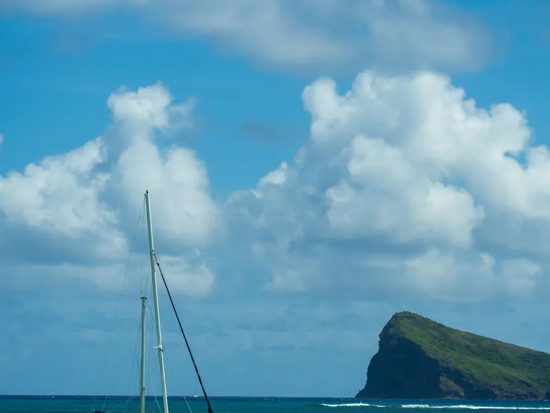 Catamaran in Mauritius with a green island on the horizon